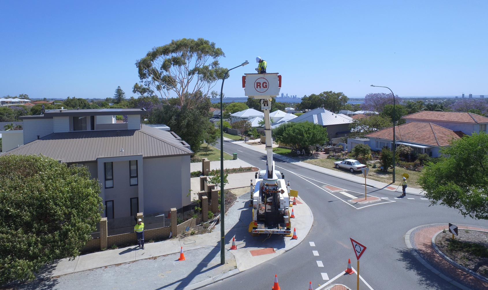 Western Power crew working on an LED streetlight in a residential suburb