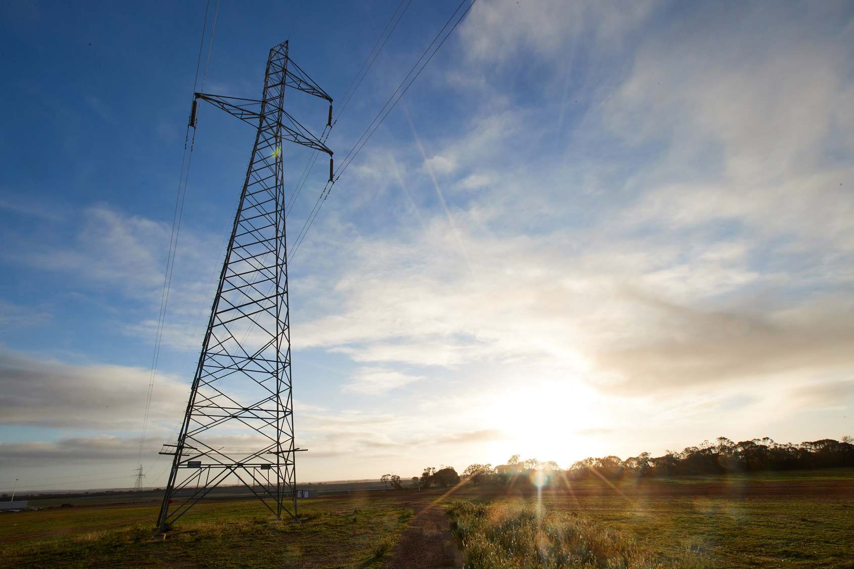 An electricity transmission tower in a field