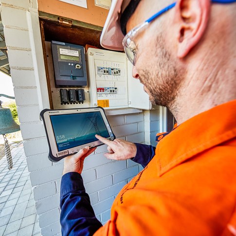 ipad and meter box with western power employee