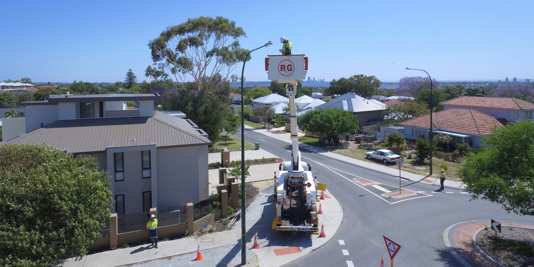 Western Power crew working on an LED streetlight in a residential suburb
