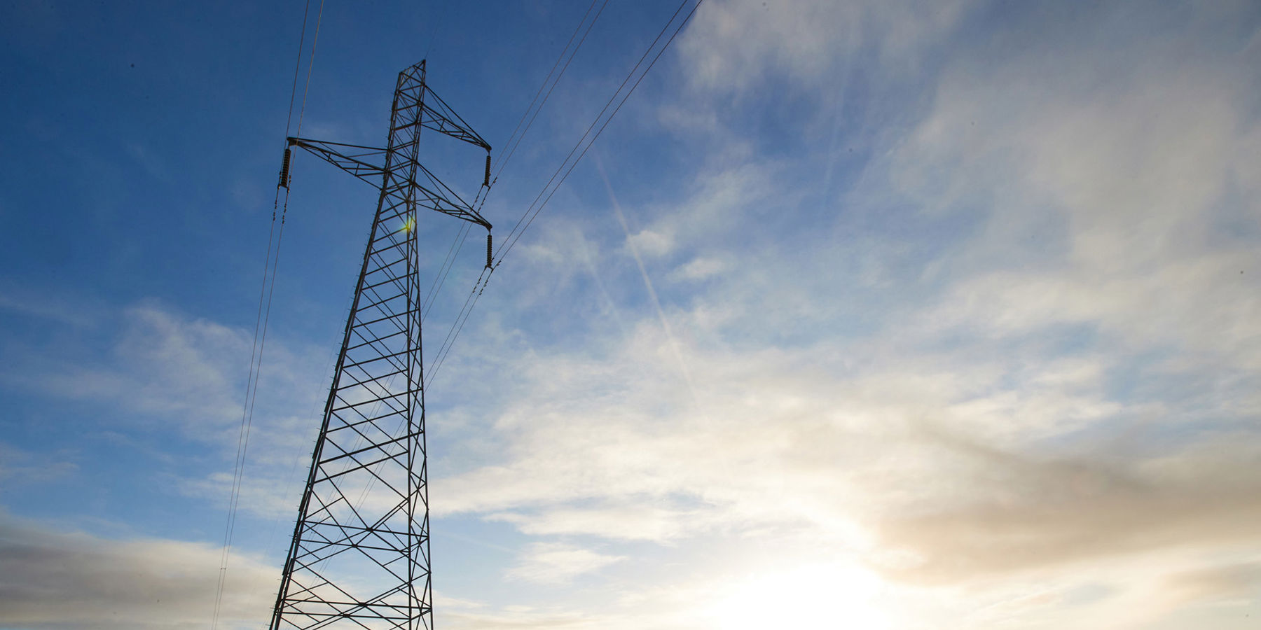 An electricity transmission tower in a field